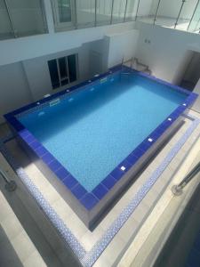 an overhead view of a large swimming pool at Bujalux apartment in Muscat