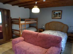 a bedroom with a bed and a couch and a chair at Studio-appartement et chambre à proximité d'une maison de Maître de 1904 in Haguenau