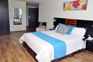 Postel nebo postele na pokoji v ubytování Hotel de las Américas - Ambato