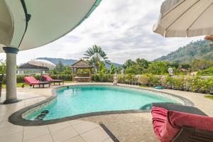 a swimming pool with a gazebo in a yard at Luxurious & Quiet Pool Villa Orchid in Nai Yang Beach