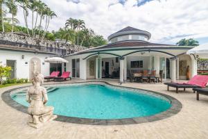 a swimming pool in front of a house at Luxurious & Quiet Pool Villa Orchid in Nai Yang Beach