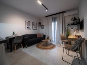 a living room with a couch and a table at Canva Living in Xanthi