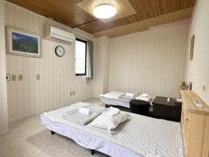 Postel nebo postele na pokoji v ubytování stay papiyon 博多 + 37 fotografií