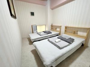 Postel nebo postele na pokoji v ubytování stay papiyon 博多