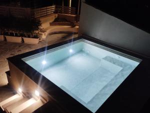 a swimming pool on top of a building with lights at Casa Badia in Santa Venerina