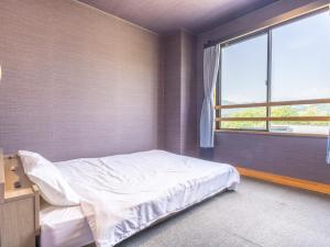 A bed or beds in a room at RV park plus Numata Kenko Land