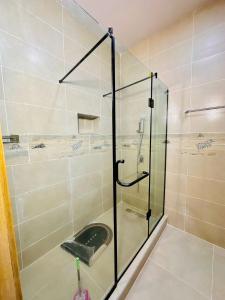 a shower with a glass door in a bathroom at Relaxing 2 Bedroom Beach Escape Lekki Abraham Adesanya Ajah in Lekki