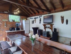 a living room with a wooden table and a television at Къща за гости АКАЦИЯ in Ravna Gora