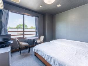 A bed or beds in a room at RV park plus Numata Kenko Land