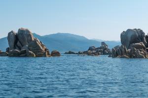 a group of rocks in the middle of the water at HOTEL CAMPOMORO in Belvédère-Campomoro
