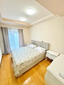 a bedroom with a bed and a large window at Apartments LUPE in Split