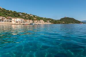 a view of a body of water with houses at HOTEL CAMPOMORO in Belvédère-Campomoro