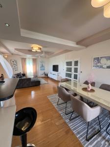 a large living room with a table and chairs at Apartments LUPE in Split