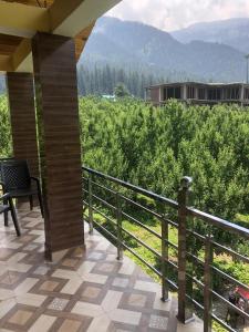 a balcony of a house with a view of a field at BIRDS LOVE HOUSe in Kalgha