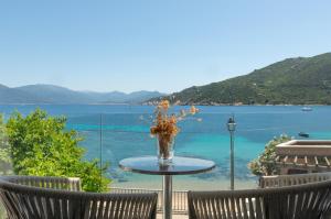 a table with a vase of flowers on top of a table at HOTEL CAMPOMORO in Belvédère-Campomoro