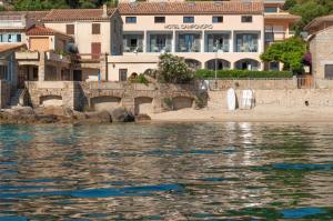 a view of a body of water with buildings at HOTEL CAMPOMORO in Belvédère-Campomoro