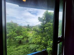 a window view of a forest from a train at The Base Central Phuket-B32YJ in Ban Rangeng