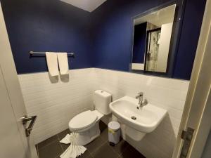 a bathroom with a white toilet and a sink at The Base Central Phuket-B32YJ in Ban Rangeng +4 photos