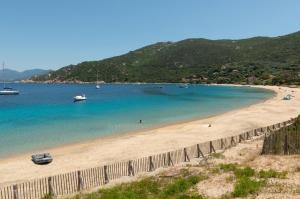 a view of a beach with boats in the water at HOTEL CAMPOMORO in Belvédère-Campomoro