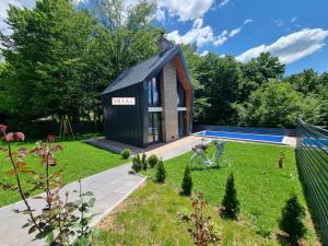 a small house with a pool in a yard at Orange Villa with private pool in Ilidza