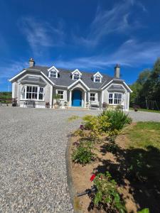 a large white house with a blue door at The Lodge in Enniscorthy