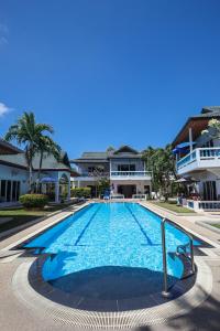 a large swimming pool in front of a building at V201 1BR Pool Access Walk to Yanui Beach in Nai Harn Beach