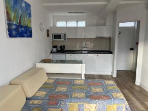 a kitchen with a couch and a table in a room at Sintra Sol - Apartamentos Turisticos in Sintra