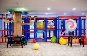 a play room with a playground with a tree at Apartament zona aeroport in Sînnicoară