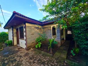 a small house with a brick exterior at A private bedroom in a shared home in Arusha in Arusha