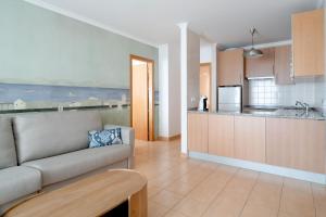 a living room with a couch and a kitchen at La Francesa Algarve in Monte Gordo +15 photos