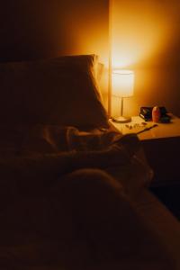 a bed with a pillow and a lamp on a table at HOTEL DEL GOLFO in Finale Ligure
