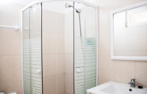 a bathroom with a shower and a sink at Sintra Sol - Apartamentos Turisticos in Sintra