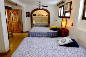 a bedroom with two beds and a lamp in it at Villa Sophie 3BR3BA Beachfront Terrace Heated Pool New Listing in Sayulita