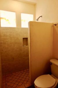 a bathroom with a toilet and a shower at Villa Sophie 3BR3BA Beachfront Terrace Heated Pool New Listing in Sayulita +16 photos