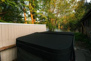 a television sitting on the side of a house at Le Chalet Brun, jacuzzi en bord de lac in Saint Adolphe D'Howard