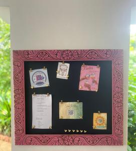 a framed picture of a wall with papers on it at Siri Beach Lodge in Nungwi