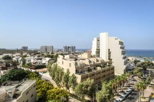 an aerial view of a city with buildings and trees at Skyline 1BR Apartment with City and Sea View Sea N' Rent in Herzliyya B