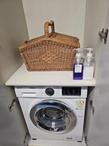 a washing machine with a basket on top of it at Happy Harbor House Stay, Incheon Airport, Wolmido, Incheon Chinatown, New Full-option, SangSang Platform, Yeonan Pier, Fairy Tale Village in Incheon