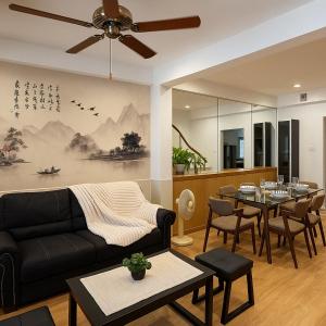 a living room with a couch and a dining room at Japanese House 3BR Home Near Ekkamai BTS in Bangkok