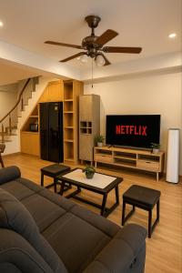 a living room with a couch and a tv at Japanese House 3BR Home Near Ekkamai BTS in Bangkok +28 photos