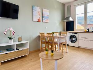a kitchen and living room with a table and chairs at L'éclat à trois pas de la mer in Ault
