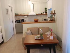 a living room with a couch and a table with wine glasses at Studio Sykea SgS in Xylokastro +17 photos