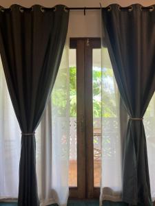 a pair of curtains in front of a window at Siri Beach Lodge in Nungwi