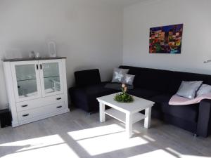 una sala de estar con un sofá y una mesa en Refugium im Brook Timmendorfer Strand, en Timmendorfer Strand