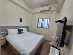 Uma cama ou camas num quarto em 幸運草輕旅