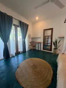 a room with a large rug on the floor and a mirror at Siri Beach Lodge in Nungwi