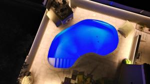 a blue swimming pool on a tiled floor at Villa RG Boutique Hotel - Adults Only in Playa del Ingles