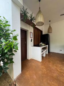 a living room with a counter and potted plants at Siri Beach Lodge in Nungwi