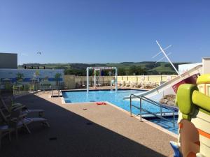 a swimming pool with a water slide in a building at Dunes Views in Prestatyn +18 photos
