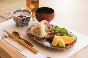 un piatto di cibo con riso e insalata su un tavolo di 温泉御宿 るりびたき a Matsumoto
